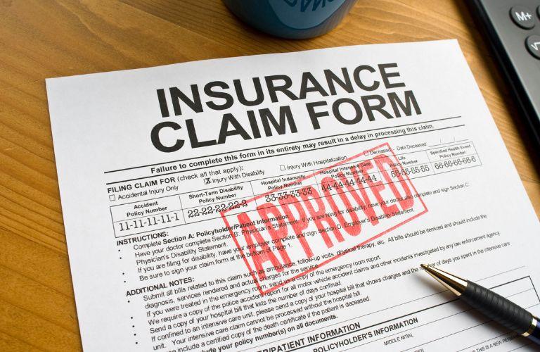 Insurance Claim Form with Red Approved Stamp