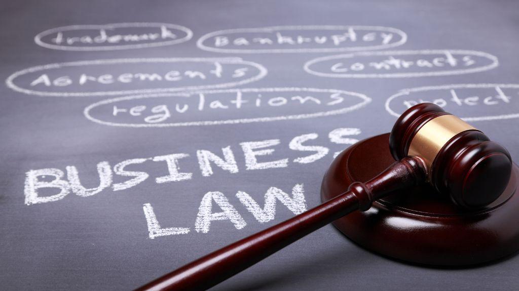 Gavel on a Chalkboard with Business Law and More Writing